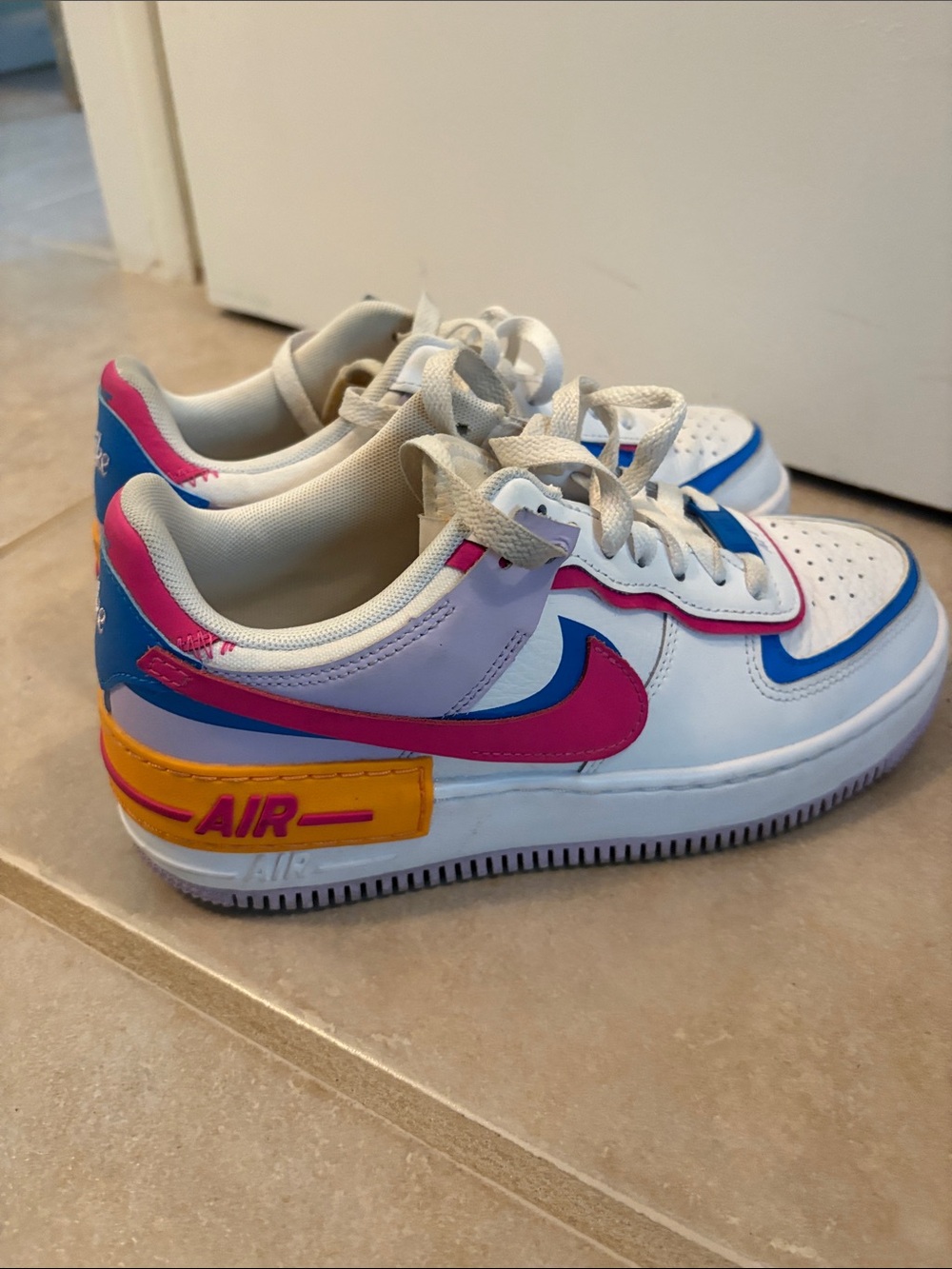 Nike White Sneakers with Pink and Blue Accents